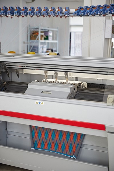 Flat-bed knitting equipment pictured in the Woolmark guide.