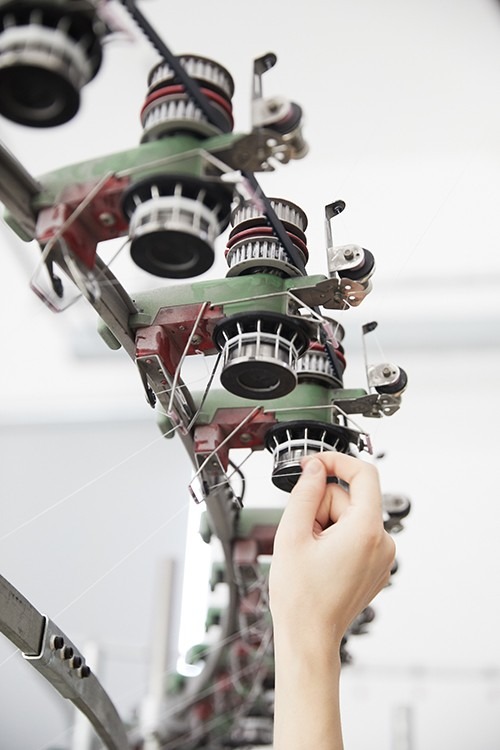 Knitting machinery pictured in the Woolmark warp-knitting guide.