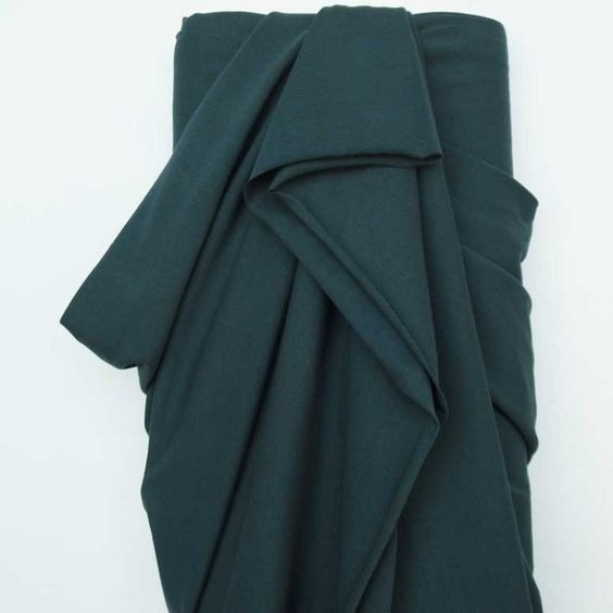 Dark cotton-elastane jersey sample pictured in the source guide.