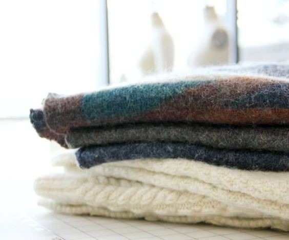 Stacked wool garments pictured in the source guide, showing finished textile surfaces.