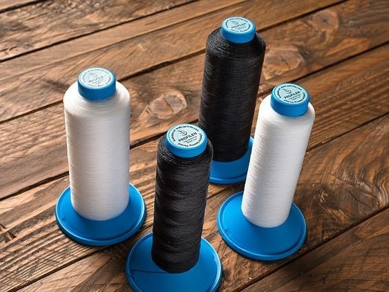 Spools of thread pictured in the source guide to PTFE.