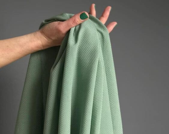 Green textile sample identified as banana fibre in the source guide.